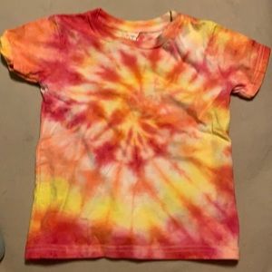 A kids white t shirt I tie dyed into a yellow pink and orange spiral